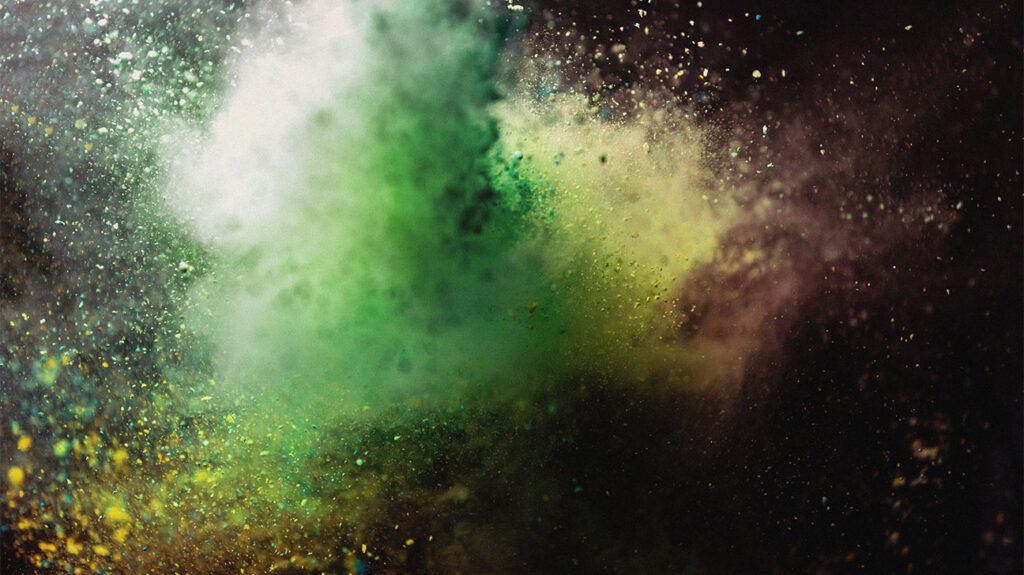 an explosion of green and yellow powder