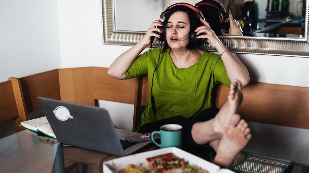 A person wearing headphones sat on a couch 1
