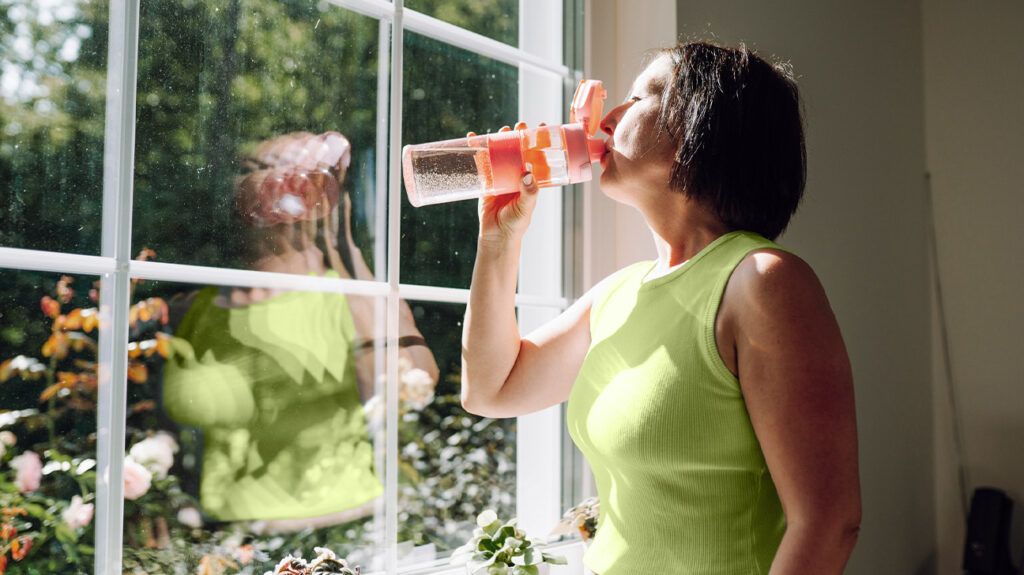A person with ulcerative colitis drinking to remain hydrated -2.