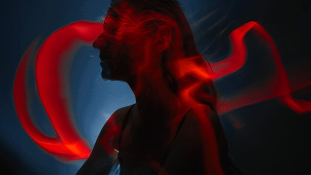 Red light trails superimposed over a person's head 1