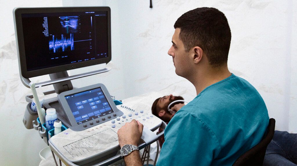 A healthcare professional checking the thyroid gland 2