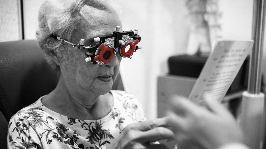An older adult with high myopic macular degeneration having an eye exam.-2