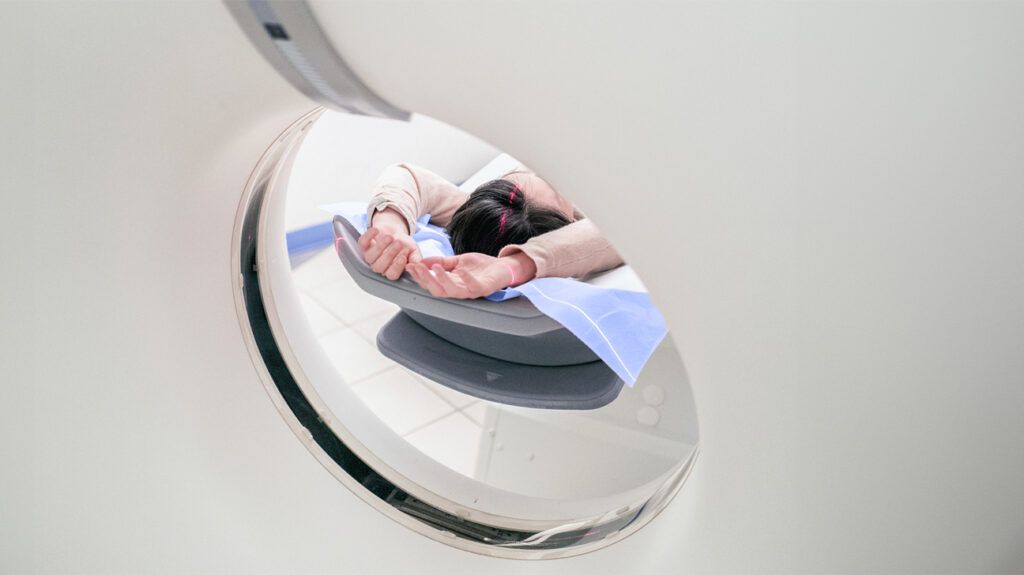 Reflection of a person undergoing an MRI for a pituitary tumor diagnosis -1