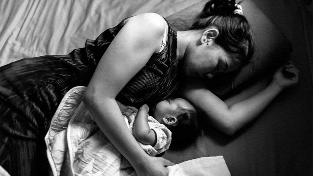 A woman with hyperlactation syndrome breastfeeding. -1 