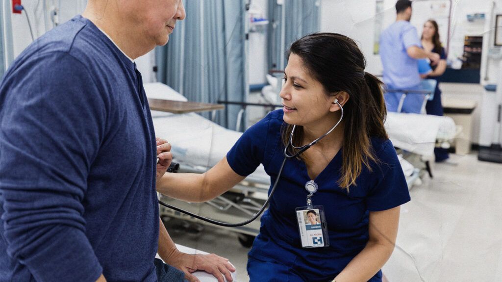 A doctor using a stethoscope to listen to a persons heart 1