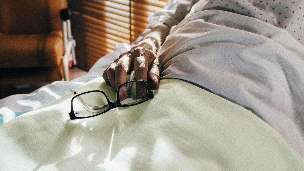 Patient with liver disease lying in hospital bed