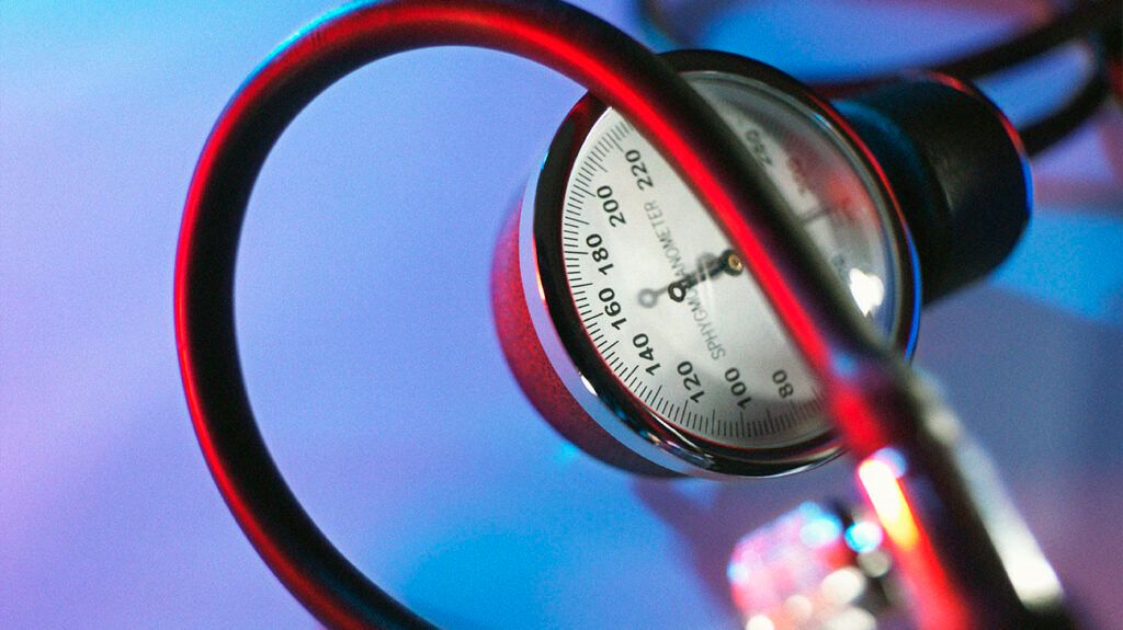 A blood pressure gauge against a blue background