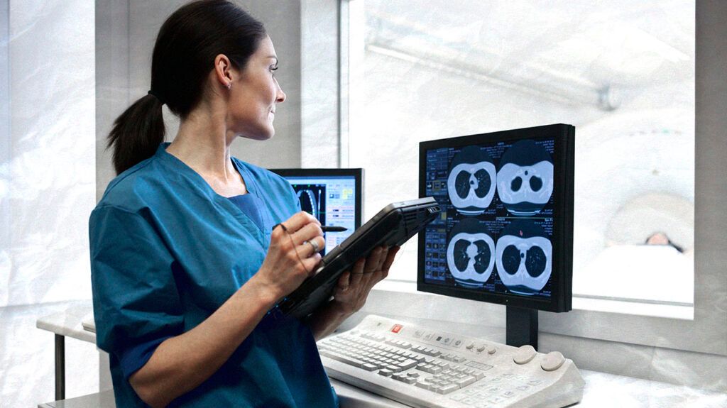 Healthcare professional reviewing a diagnostic scan