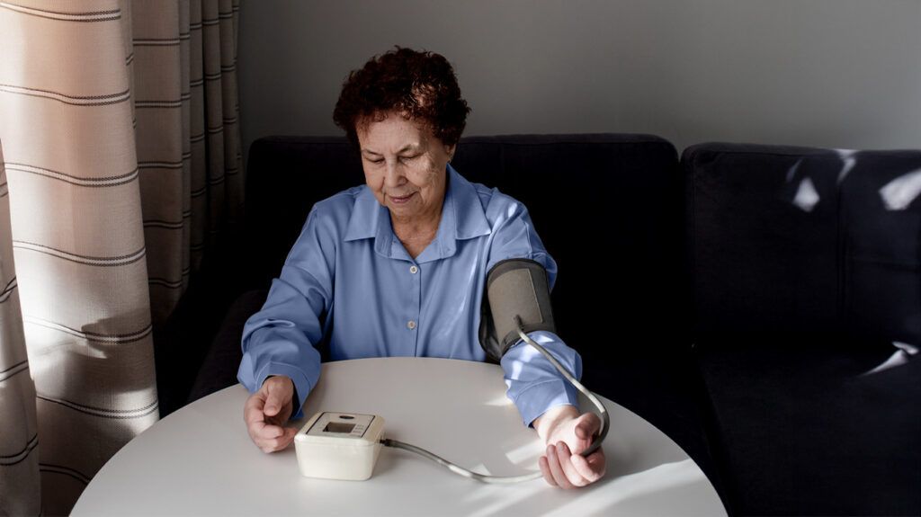 Older female checking her blood pressure