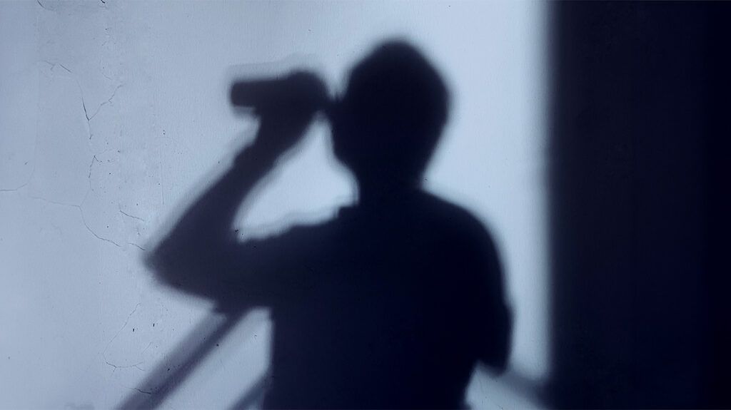 A silhouette of a person drinking alcohol.-1