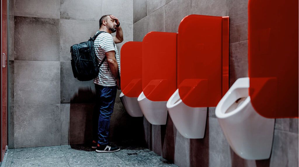 Male standing at a urinal
