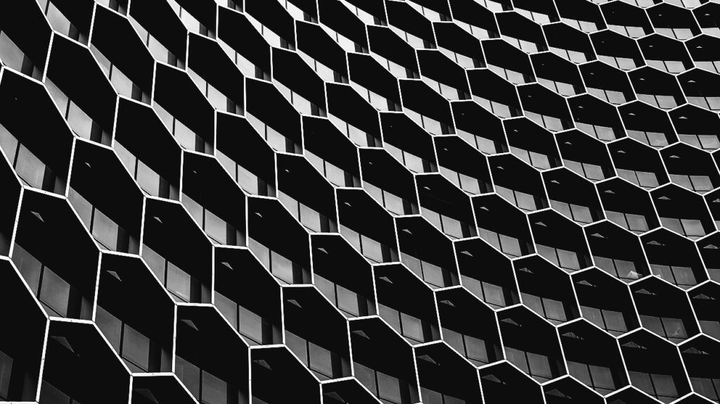 Black and white image of the side of a building with rows of windows