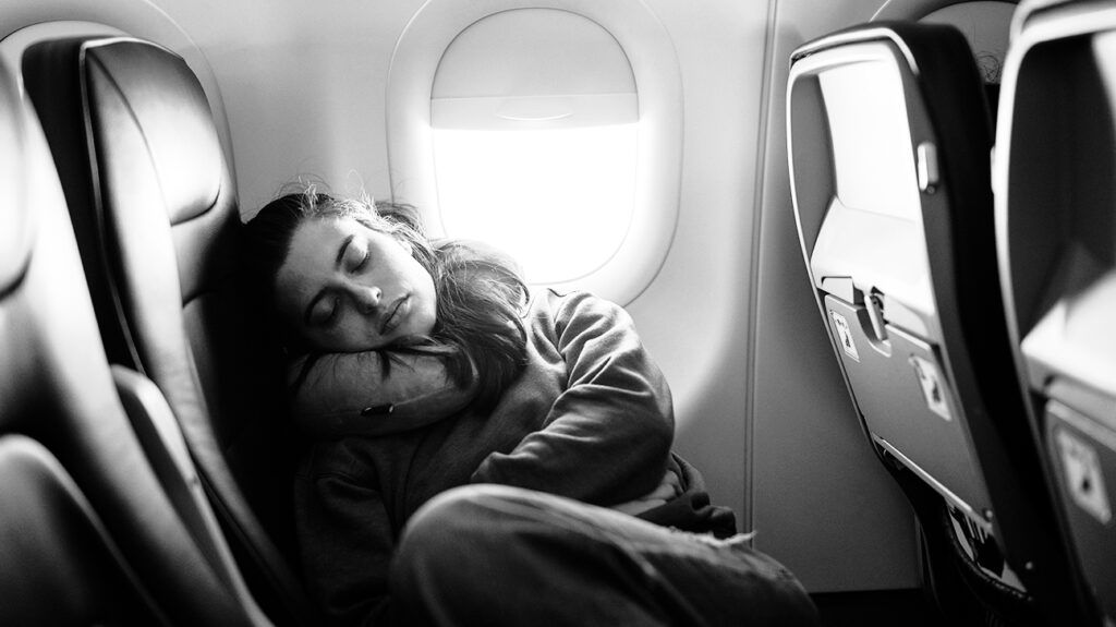 A person sleeping on a plane-1.
