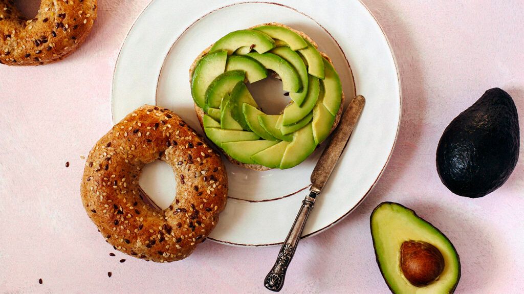 Sliced avocado on an everything bagel
