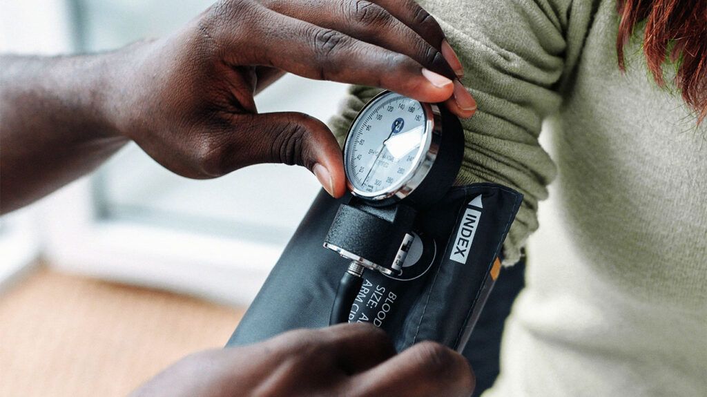 A doctor checking blood pressure