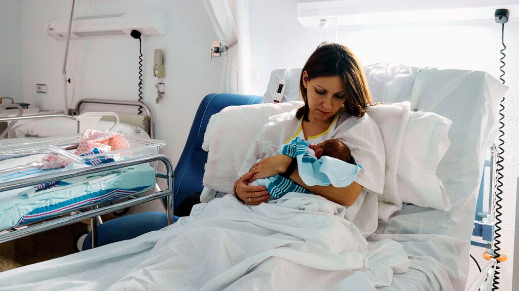 Female with a newborn in a hospital bed
