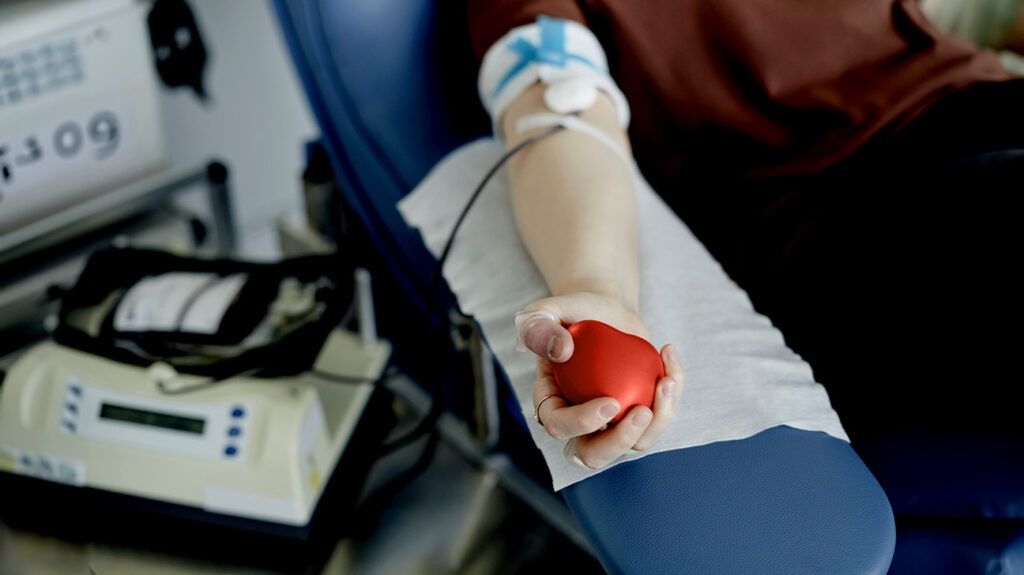 A person's arm donating blood