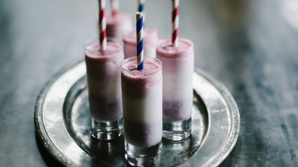 Frozen yogurt with straws in glasses