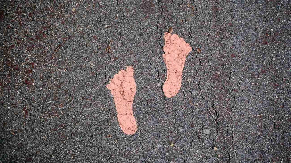 Two painted footprints on a path