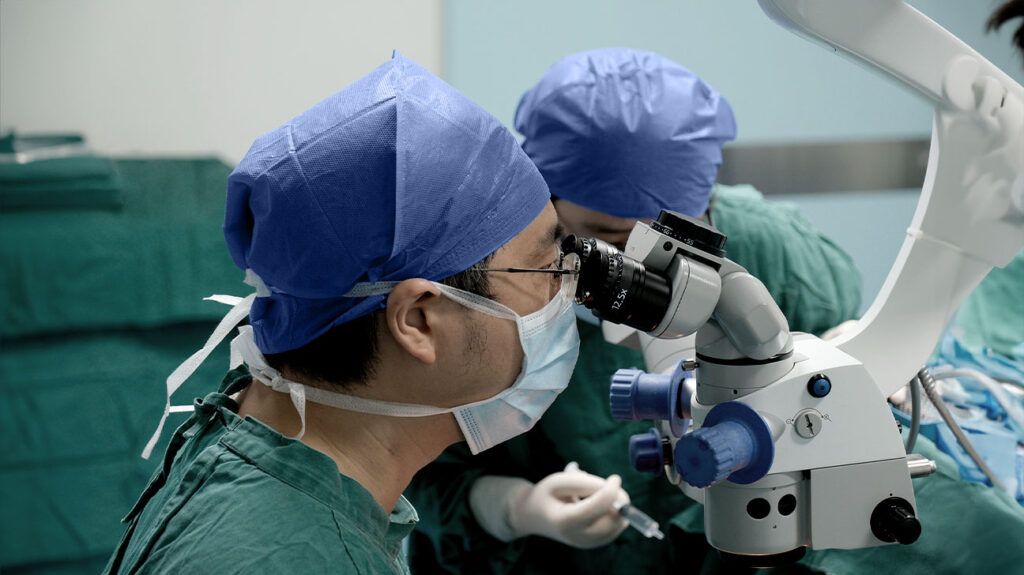 Two surgeons performing laser eye surgery