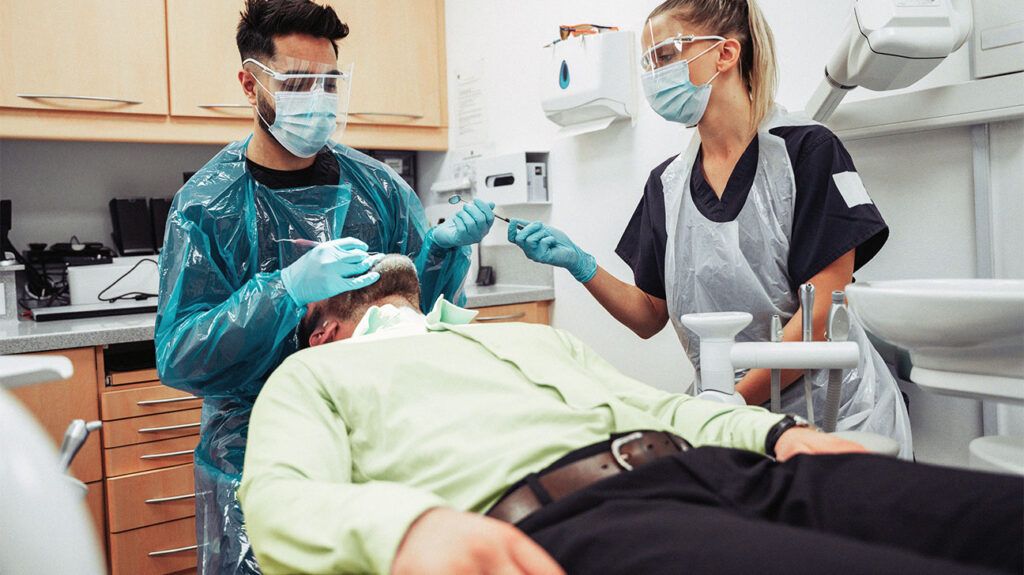 A person in the dentist chair having a tooth extraction-1