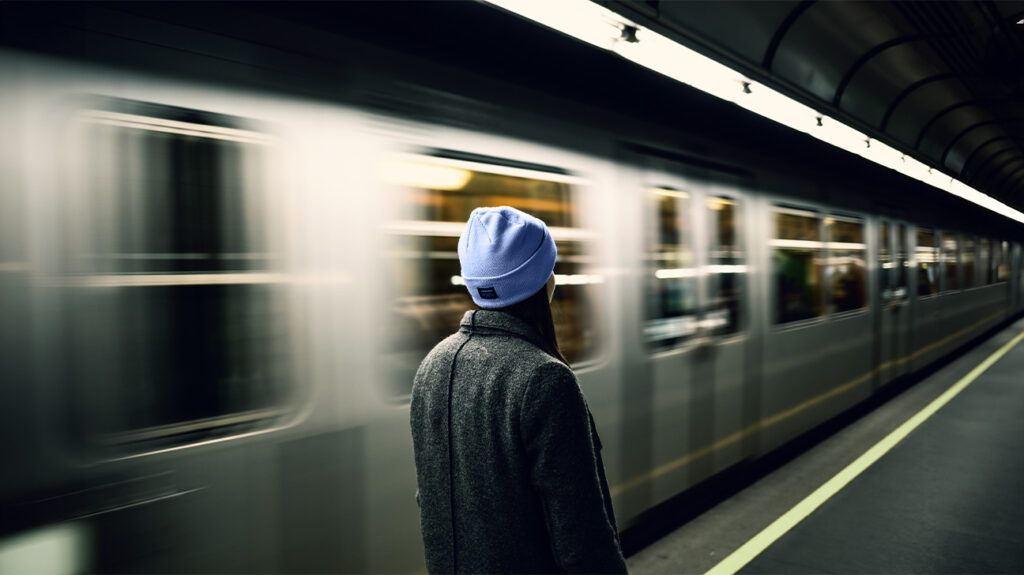 Person on a platform with a train passing