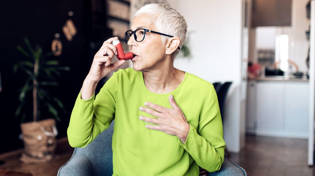 person using an inhaler