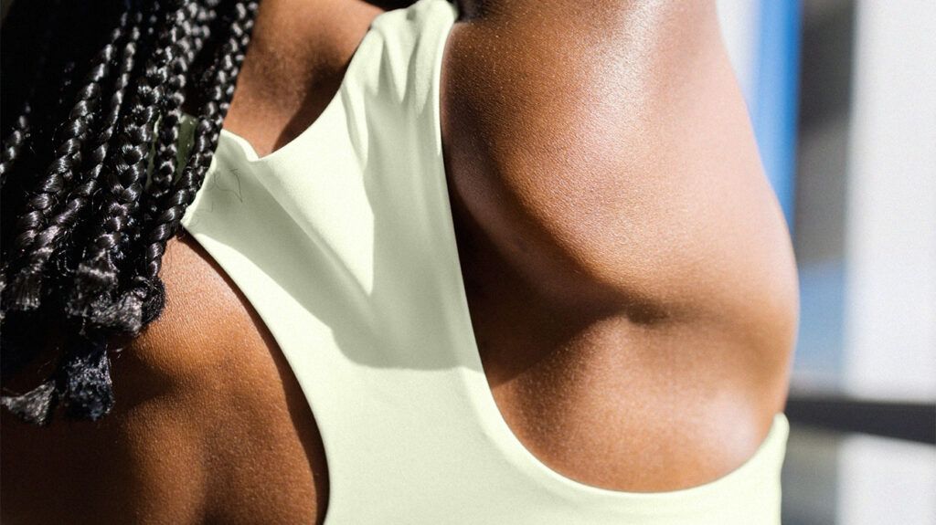 A close up of an exercising woman's back
