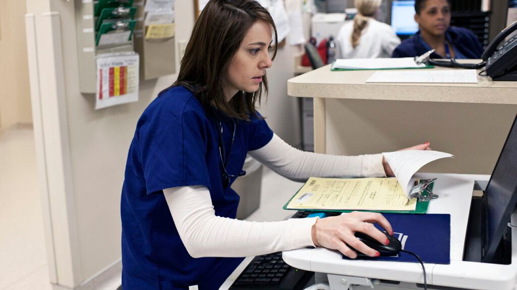 A healthcare professional using a computer 1