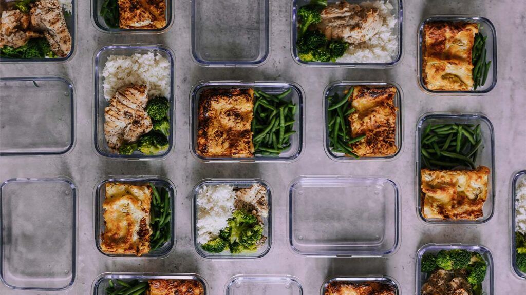 Plastic containers with healthy lunches inside