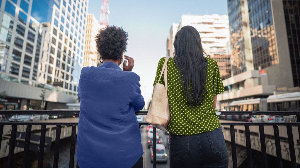 Two females in a city talking