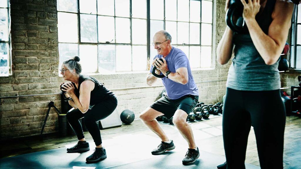 Older adults lifting weights at the gym.