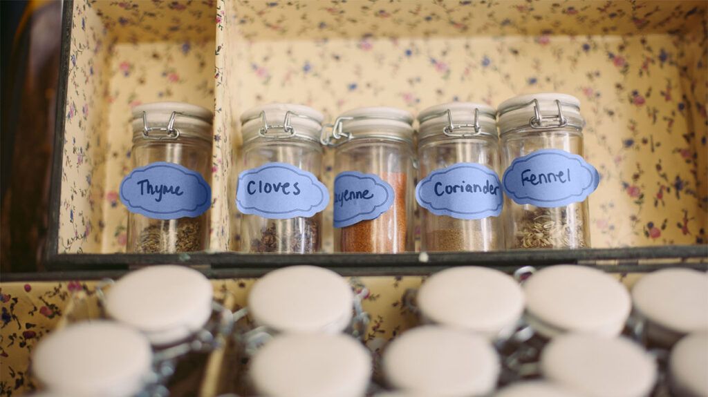 Glass jars of various spices in a box