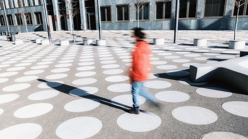 A person walking on a surface with white spots 1