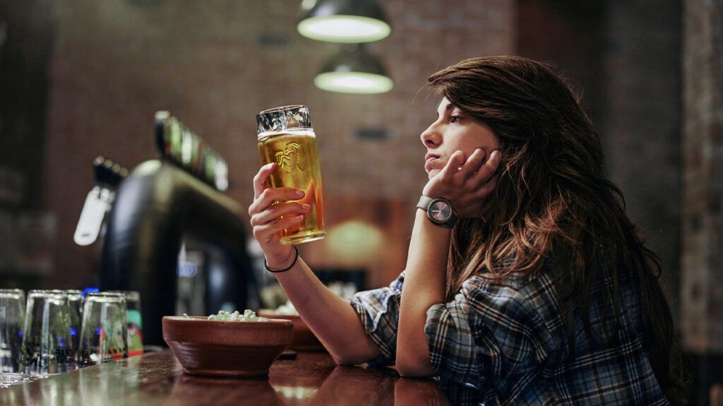 A woman drinking alone at a bar -2.