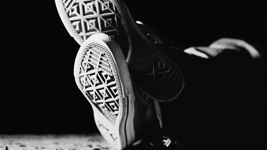 black and white photo of sports shoe soles