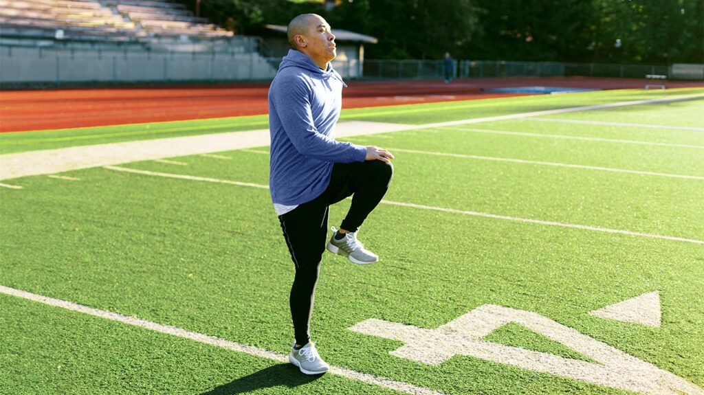 Male exercising on a football field