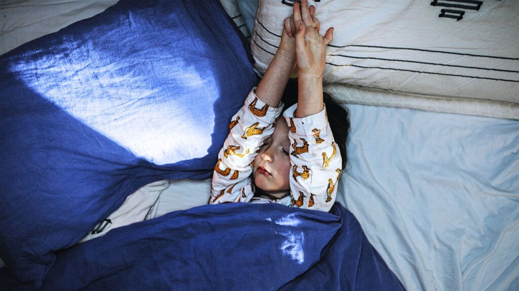 A child lying in bed 1