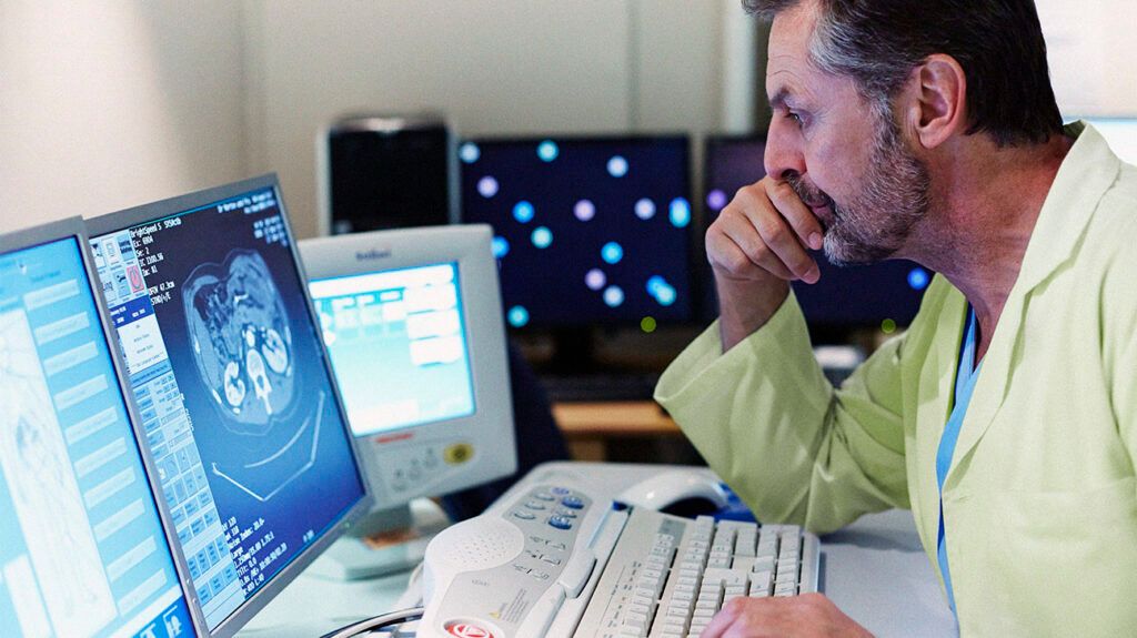 A doctor examining imaging test results of someone with diverticulitis and colon cancer.-2