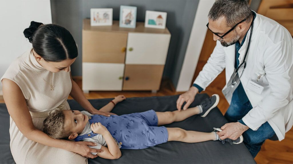 Doctor checking a child's legs
