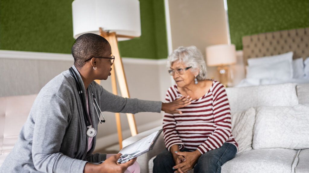 A healthcare professional touching a persons chest 1