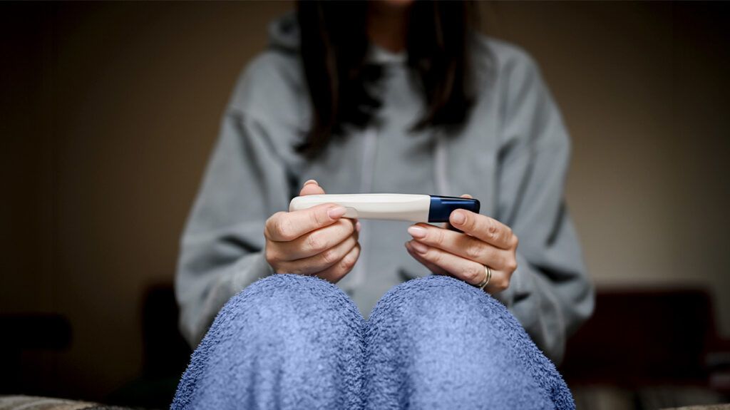 Female holding a pregnancy test