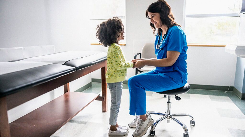 A medical professional is talking with a child.