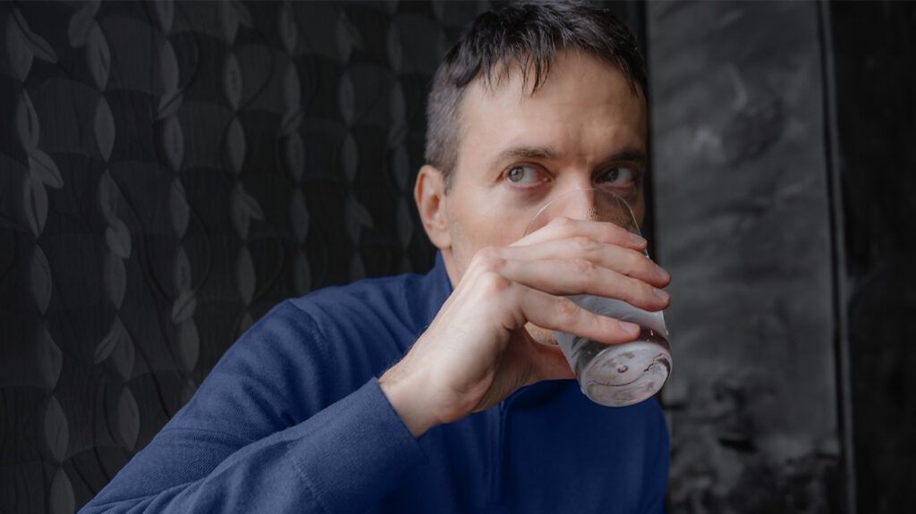 A person drinking a glass of water-1.