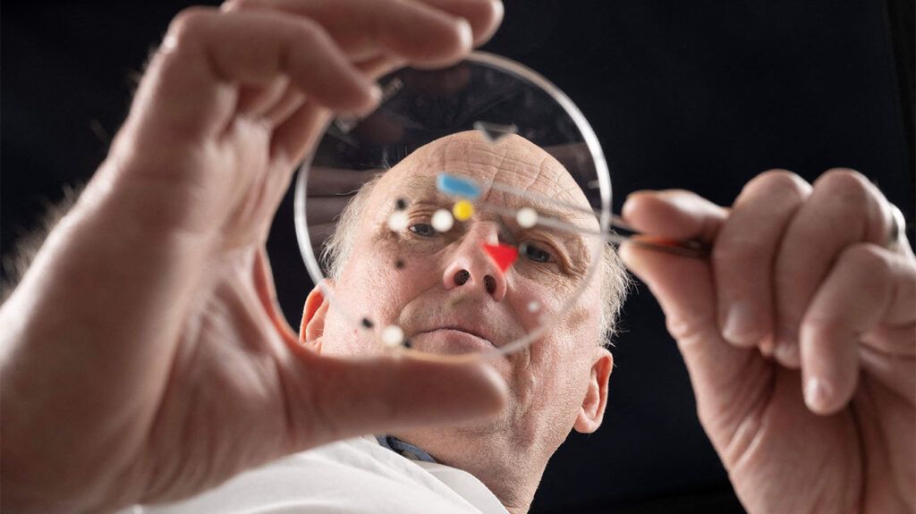 older white male researchers analyzing plastic samples in petri dish