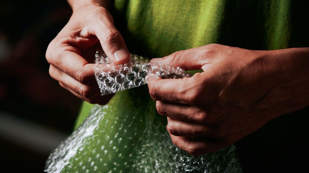 Person popping bubble wrap