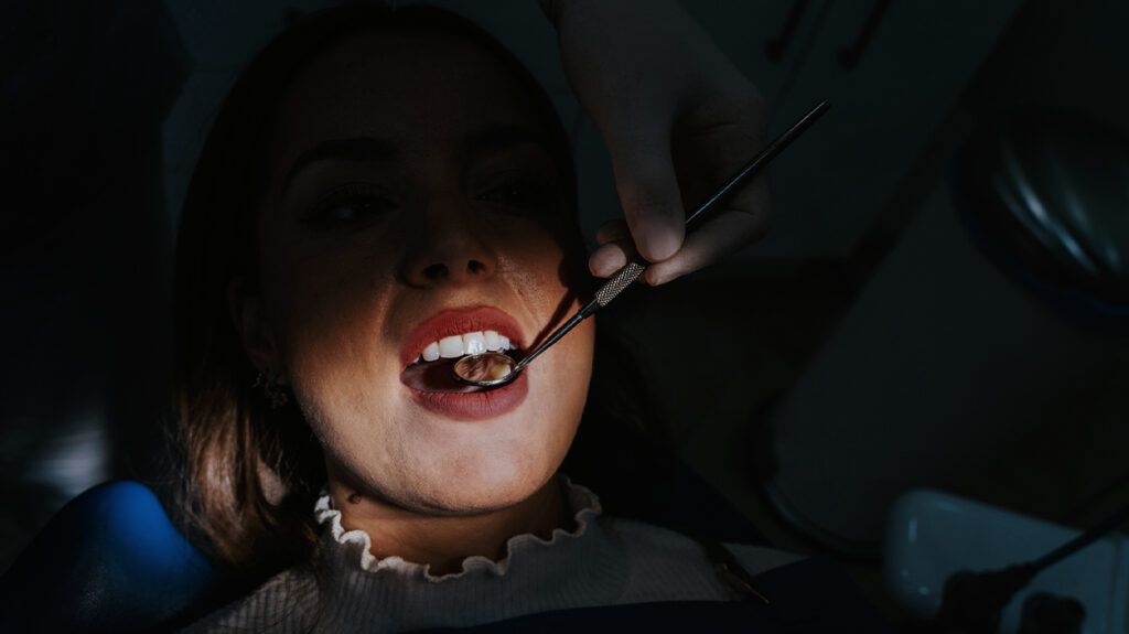 A woman with her mouth open at the dentists -2.