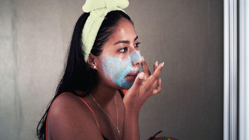 person applying a facemask 