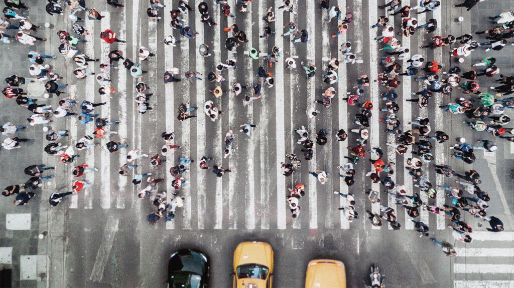 aerial shot of a crowd of people on a large crossing