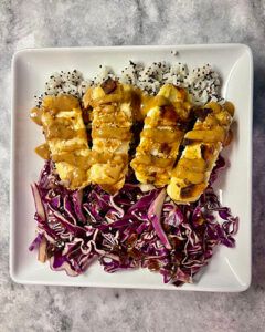 Purple Carrot meal kit of coconut tofu and purple cabbage on display plate